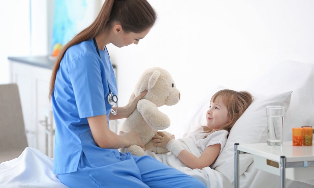 tic disorders represented by child in hospital bed and nurse playing with her