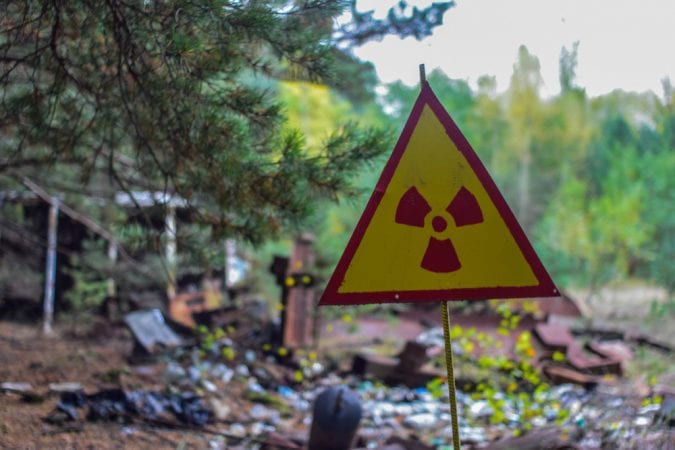 Radioactive sign in front of abandoned street
