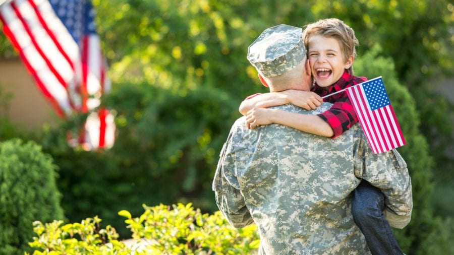 VA cannabis policy represented by Soldier being embraced by very happy 8 year old son, VA