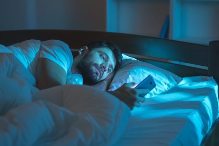 Man awake in middle of night looking at phone didn't take best edibles for insomnia