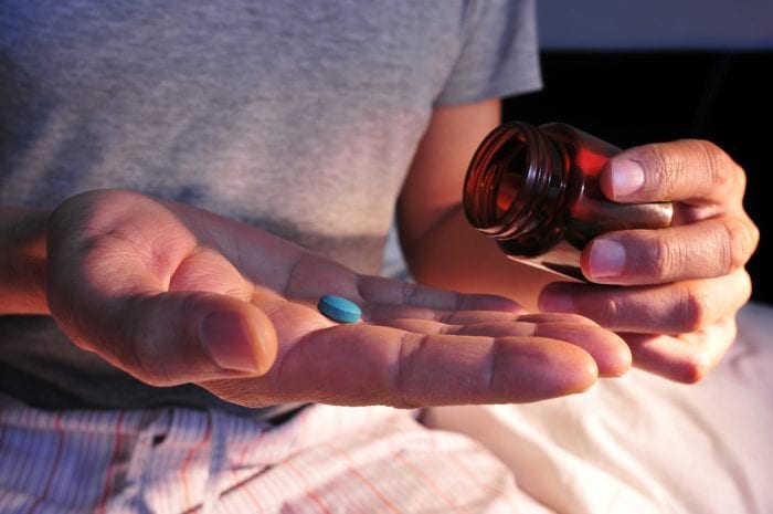 is cannabis a good sleep aid represented by pill in open hand
