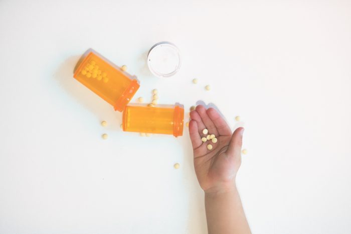 holding pills with spilled bottle