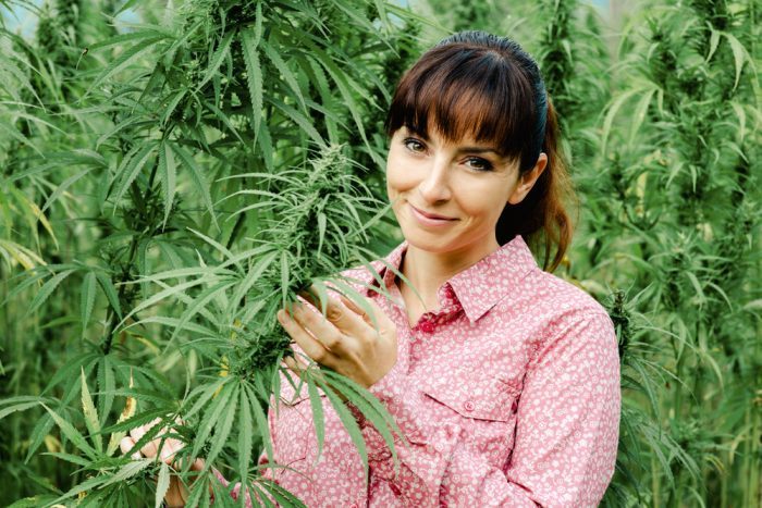 woman with cannabis plants