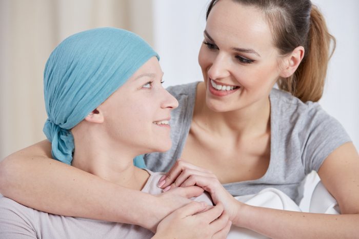 cancer patient and her friend in embrace