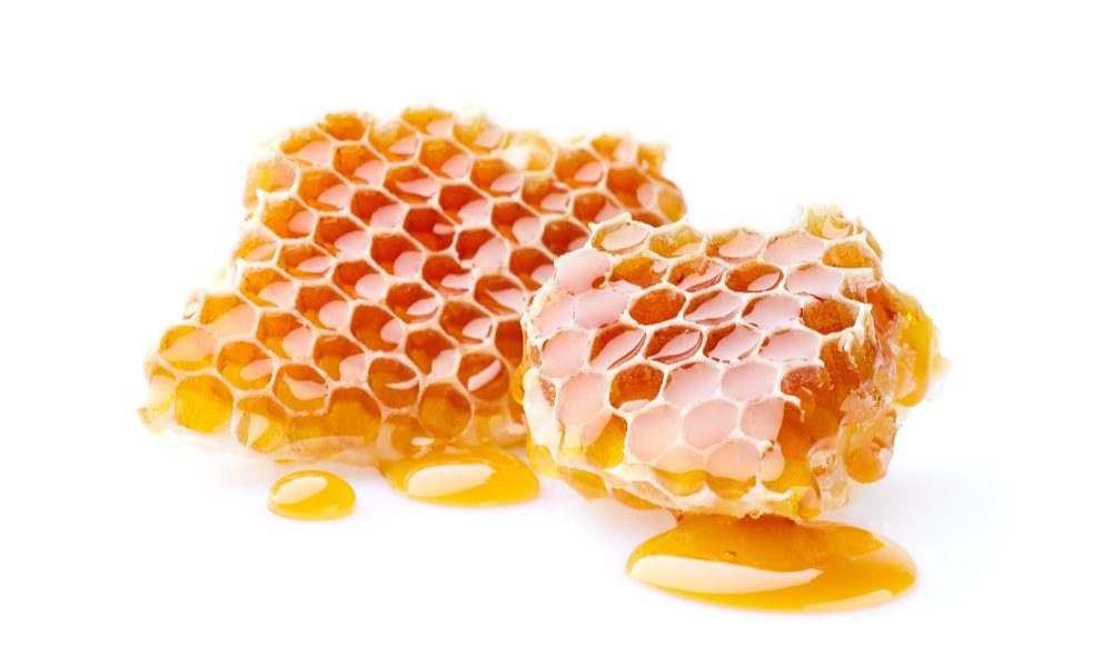 honey sticks represented by comb of dripping honey