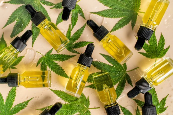 cannabis oil bottles and leaves spread out