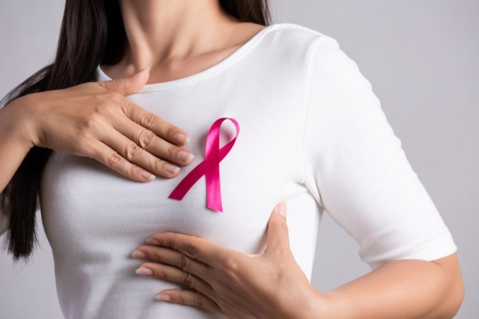woman showing breast cancer ribbon