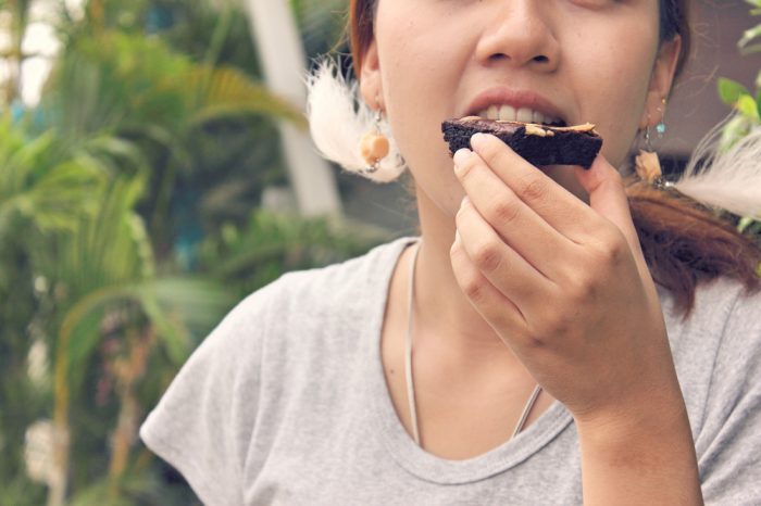 how long do edibles last represented by girl eating brownie