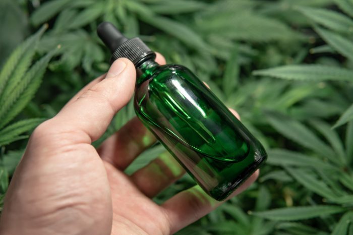 cbd oil bottle in hand that might stop working if you don't know these tips