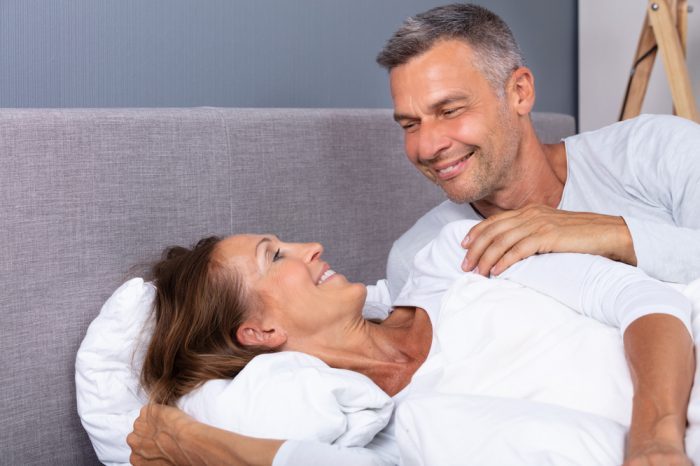 cbd lube hinted at by older couple happy laying in bed