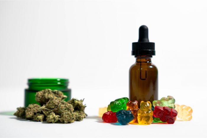 How long does CBD stay in your system represetned by cbd bottle, gummies, and buds