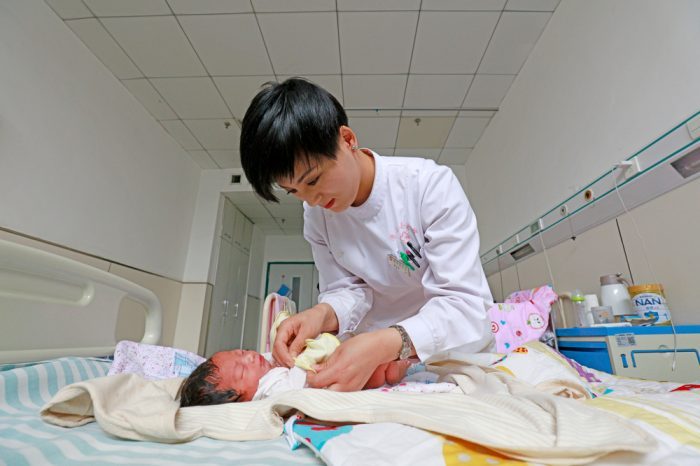 doctor tending to newborn baby