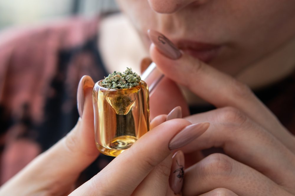 CANNABINOIDS AND TERPENES might be in the pipe that this young woman is smoking