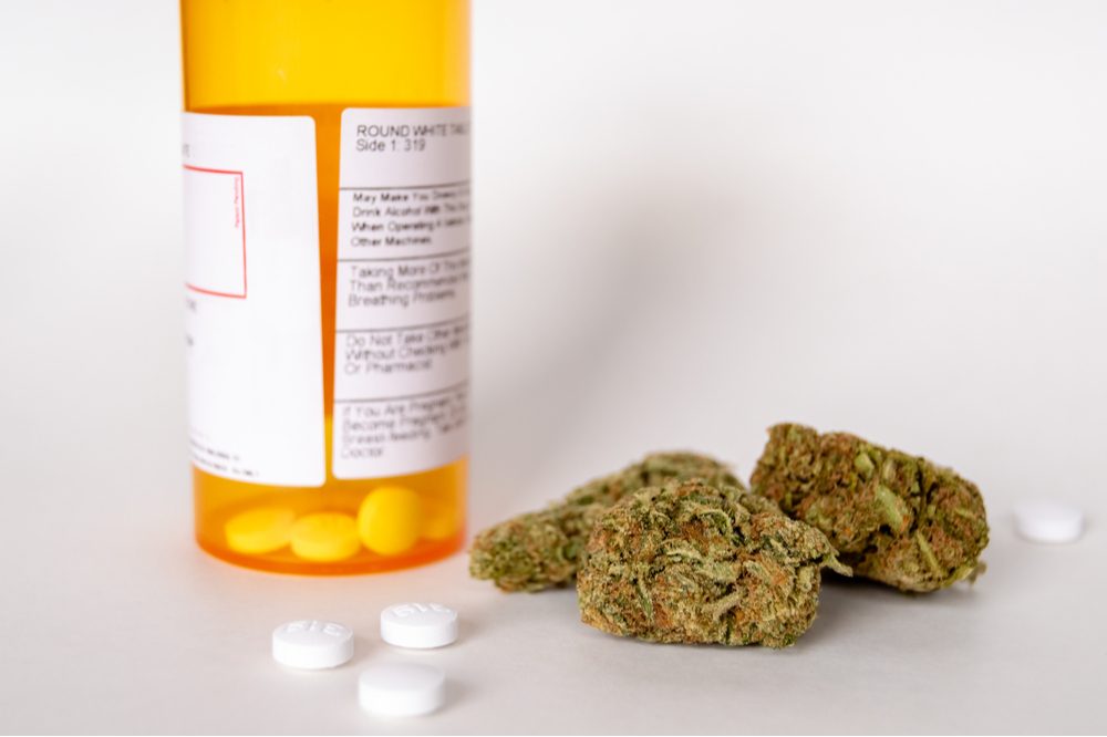 pain pills next to cannabis bud