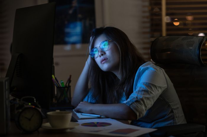real world data represented by young asian woman lworking on laptop