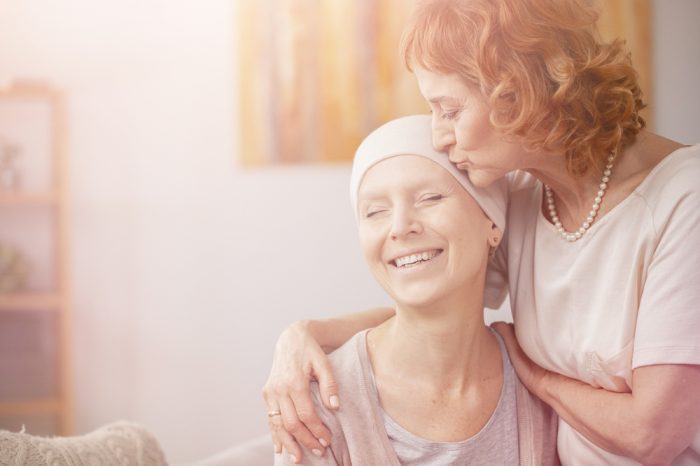 terminally ill patinets like this white female cancer patient being kissed on her headwrap are great cannabis patients