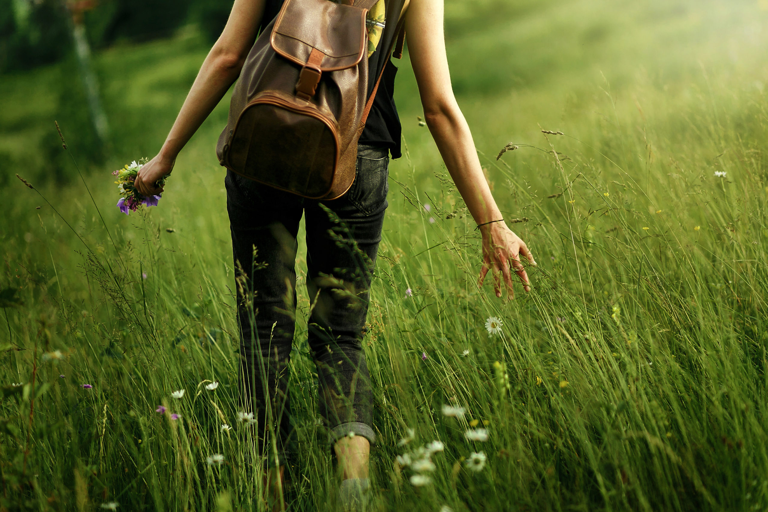 RxLeaf Naturals category represented by woman walking in field of grass