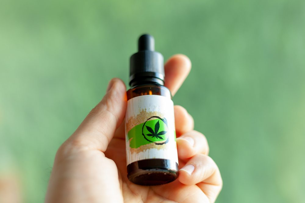 bottle of CBD held up for the camera 