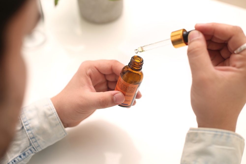 can I give my child CBD oil represented by white doctor or father taking cbd oil out of syringe