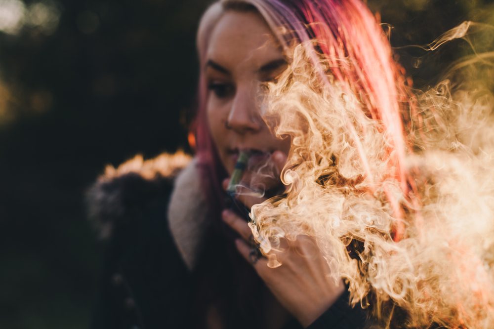 CBD and Women's Health represented by woman smoking cannabis