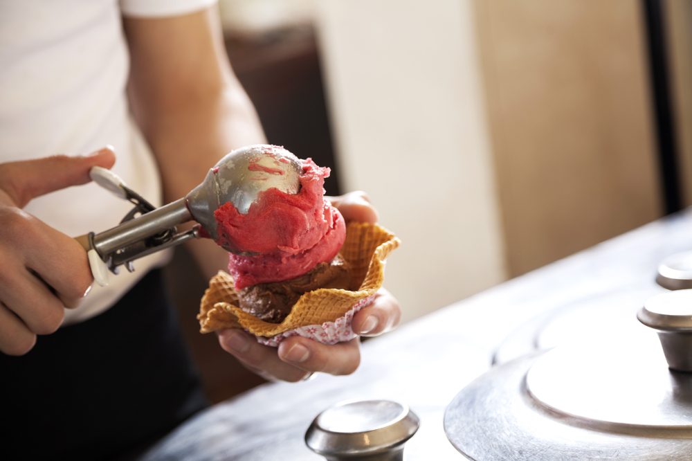cbd ice cream represented by hand scooping cone