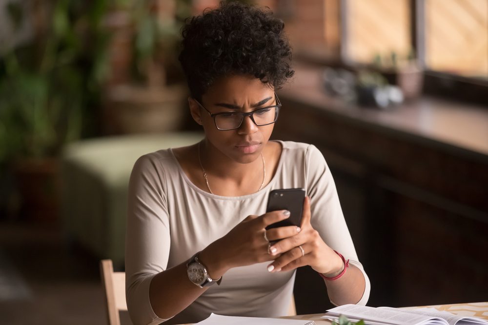 buy cannabis online represented by young black female looking at phone