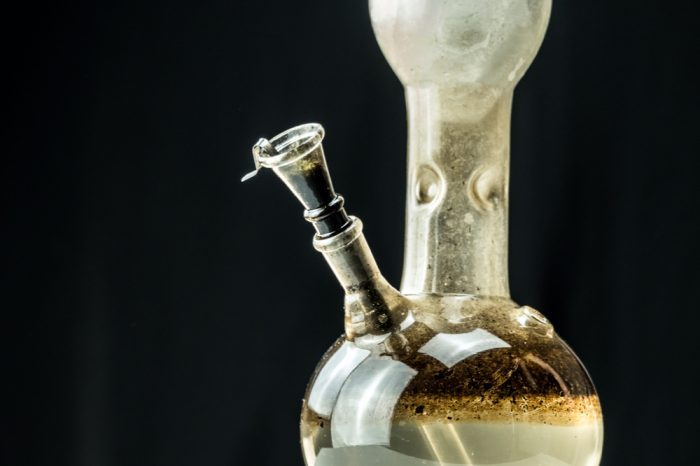 how to clean a bong represented by filthy bong on black background