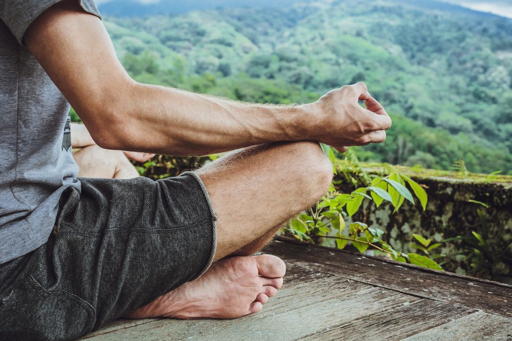 vegan athletes represented by meditating man near cannabis