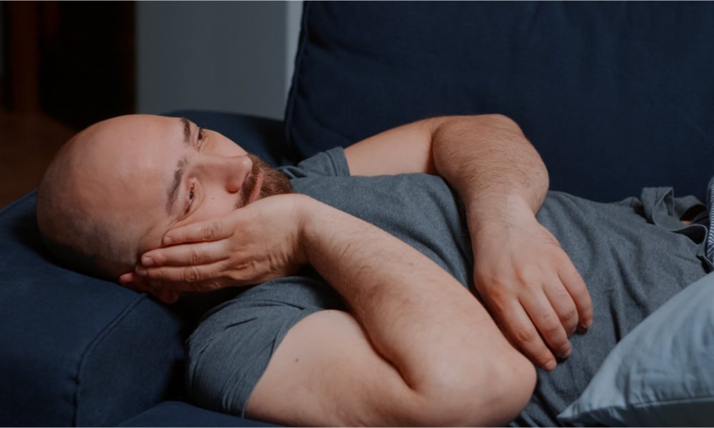 stop chronic pain represented by man laying in pain in bed